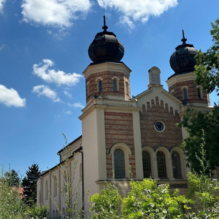 The twin towers of the Synagogue in Trnava, Slovakia, against a blue sky, seen during a day trip to Trnava.