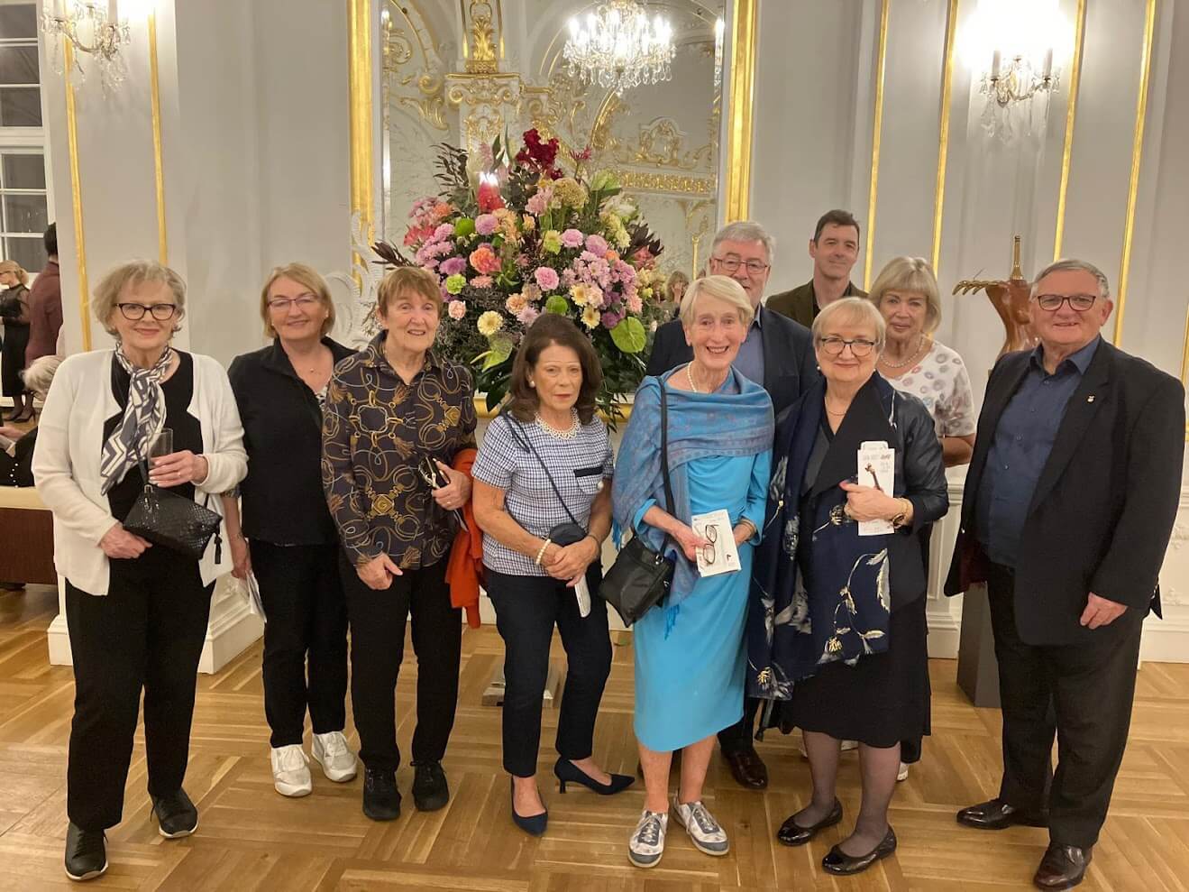 Irish senior clients posing in a building of Slovak Philharmonic Orchestra called also Reduta prior concert during their Bratislava Musical Festival Tour